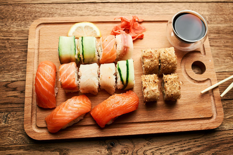 High angle view of sushi served on cutting board