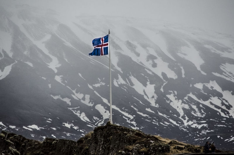 Icelandic flag on snowcapped mountain