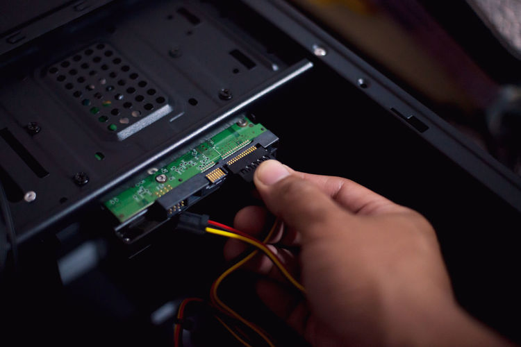 Cropped hand repairing computer equipment