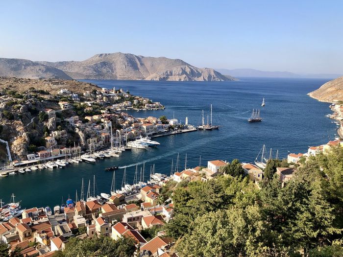 Symi island panoramic view from the top of hill. marina, yachts, colourful houses, mountain.