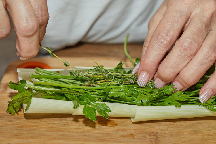 Midsection of man cutting vegetables on table