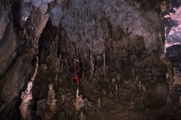Man standing on rock in cave