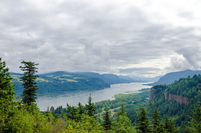 Scenic view of columbia river gorge against cloudy sky