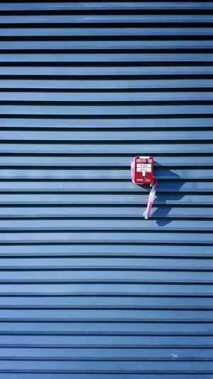 Fire alarm on corrugated wall