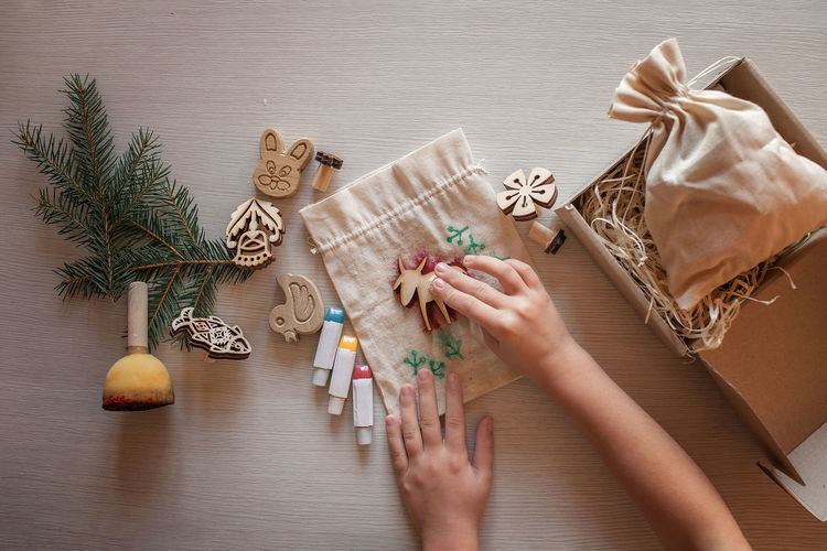 Cropped hand of woman holding christmas tree