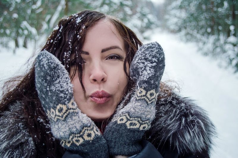 Close-up portrait of a woman in snow