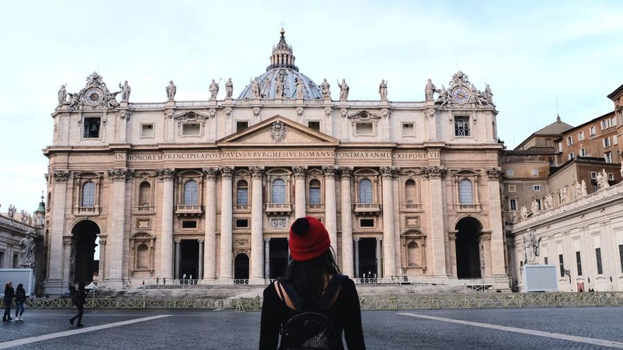 Rear view of woman standing in front of st peters basilica