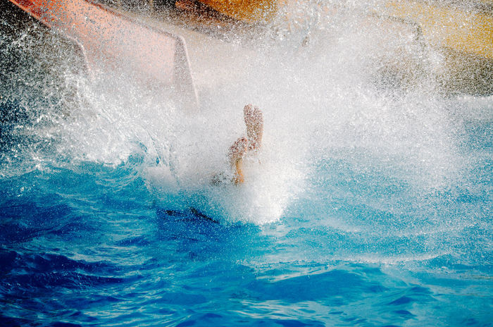 High angle view of man splashing water in pool at aqua paradise ltd water park