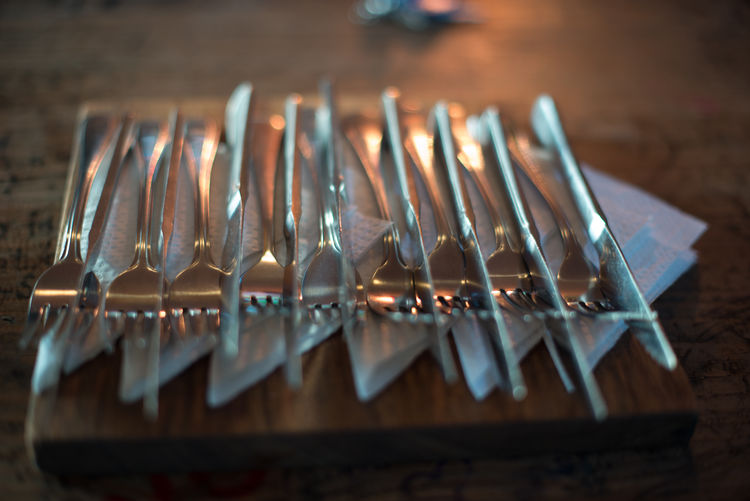 High angle view of forks and knives on table