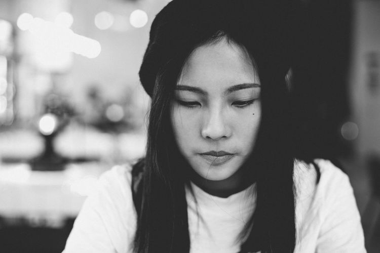 Close-up of thoughtful young woman at cafe