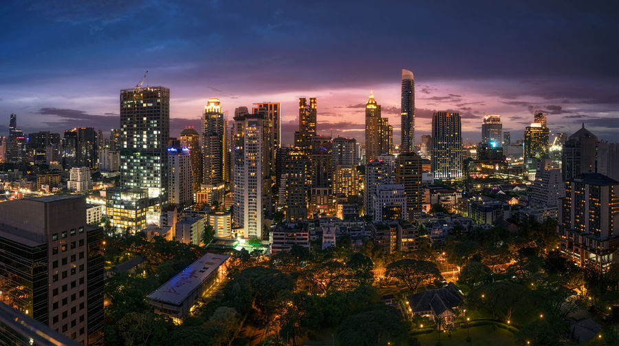 Illuminated skyscrapers against sky at twilight at lang suan district