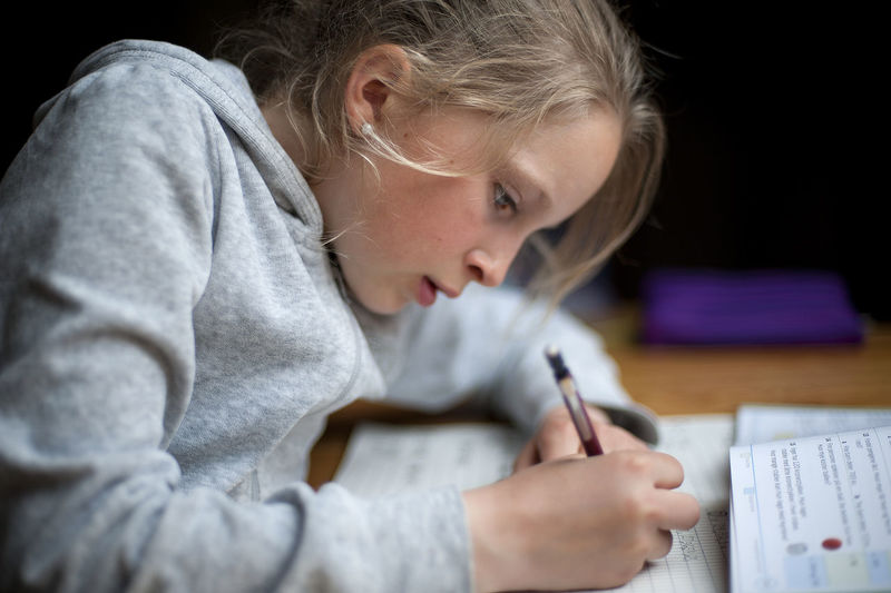Close-up of girl studying