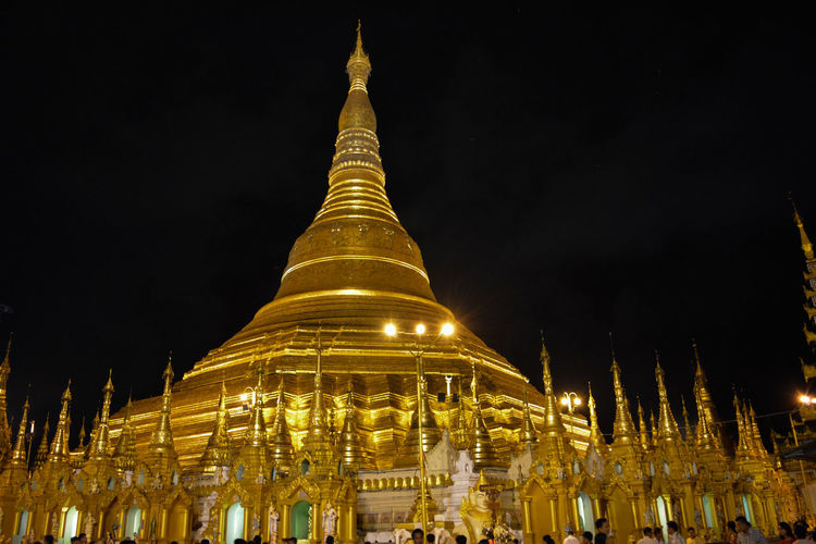 Low angle view of illuminated pagoda against sky at night