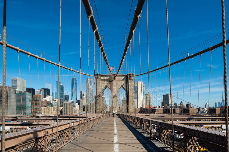 Brooklyn bridge against blue sky