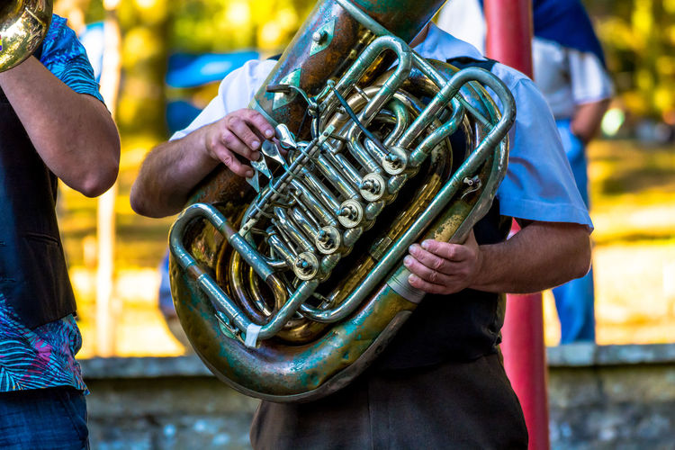 Men playing tuba at event