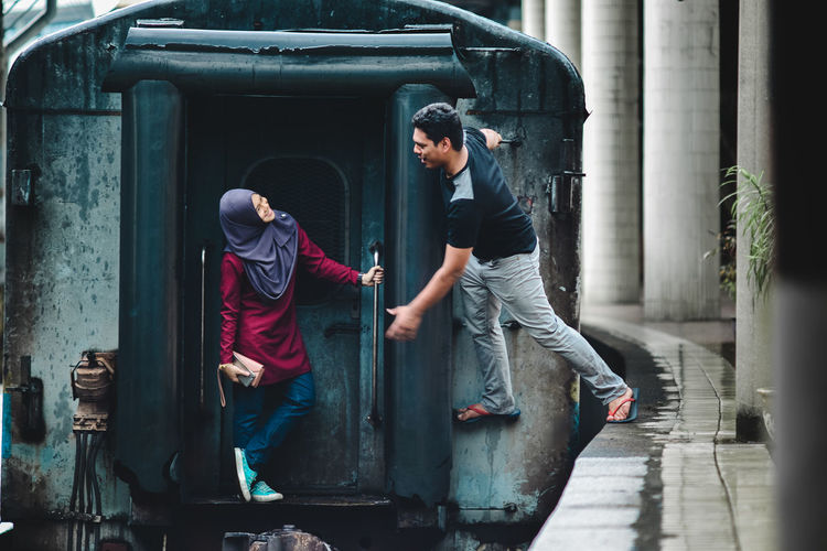Couple standing on train in city