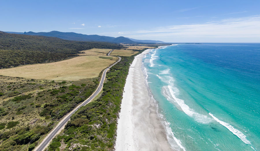 Drone view of denison beach and the a3 tasman highway near bicheno, east coast tasmania, australia.
