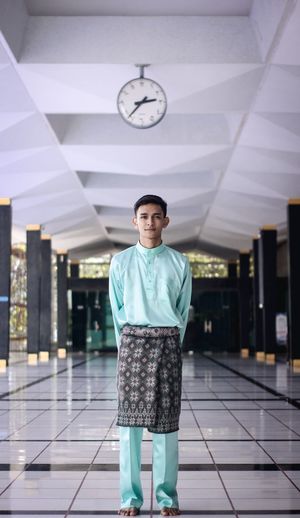 Portrait of man standing in corridor