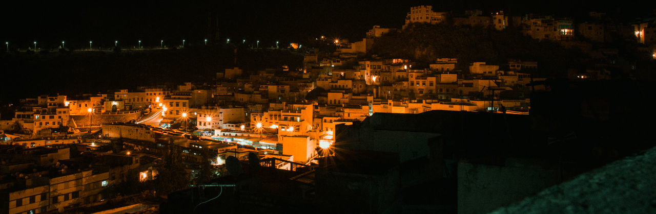 High angle view of illuminated buildings in city at night