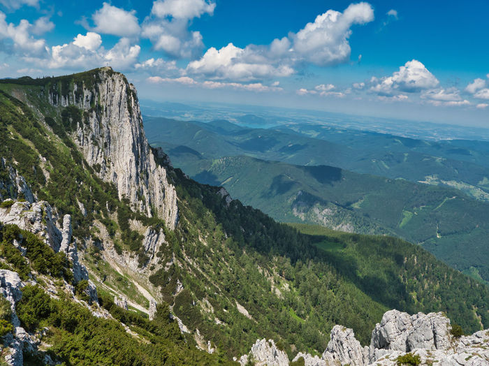 Scenic view of valley and mountains against sky