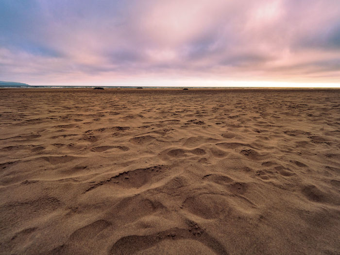 Scenic view of beach against sky during sunset