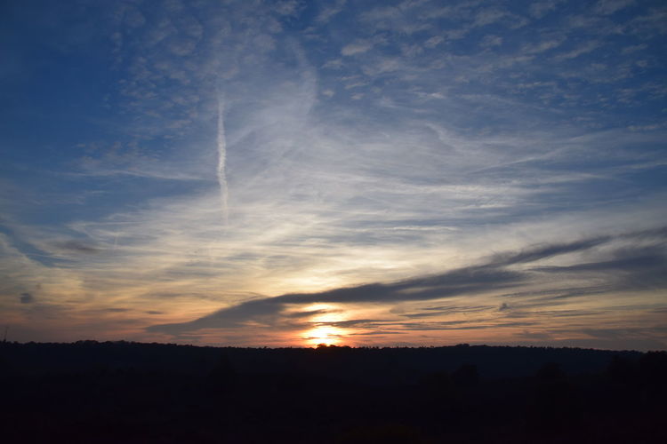 Silhouette landscape against sky during sunset