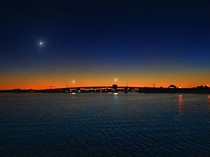Scenic view of sea against sky at night