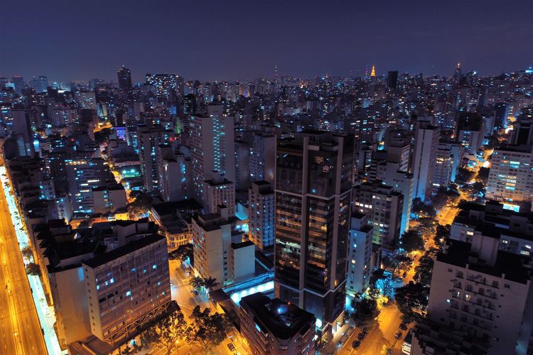 High angle view of illuminated buildings in city at night
