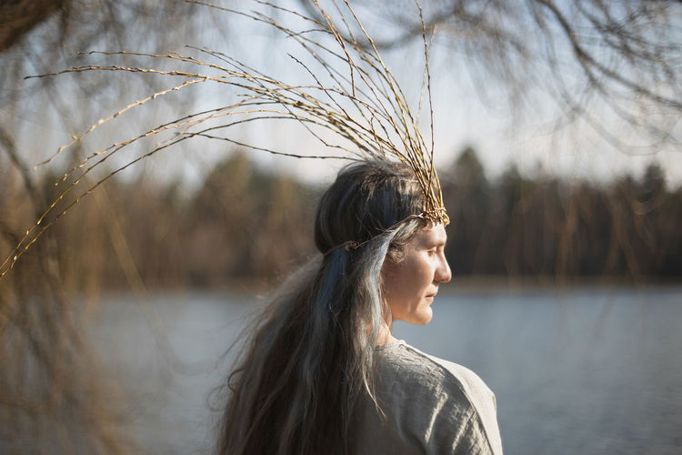 Close up middle age woman with willow branches crown portrait picture