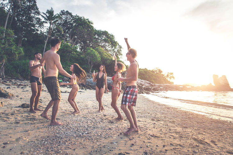 Friends enjoying at beach during summer