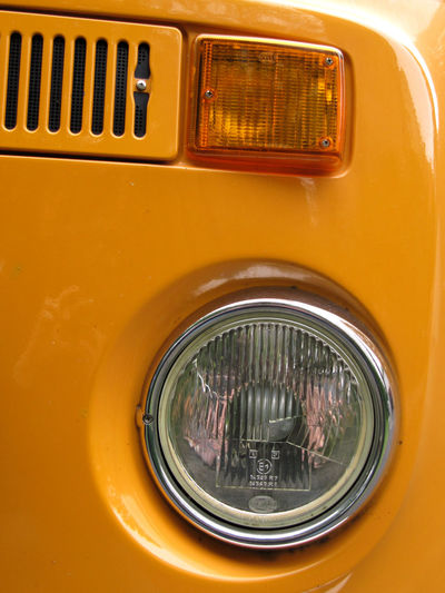 Close-up of orange vintage car headlight