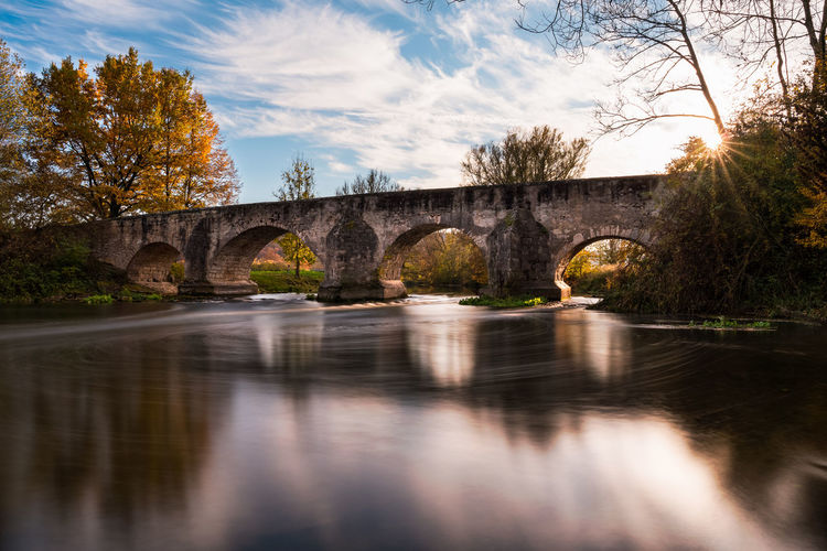 Arch bridge over river altmühl lighten up in autumn mood