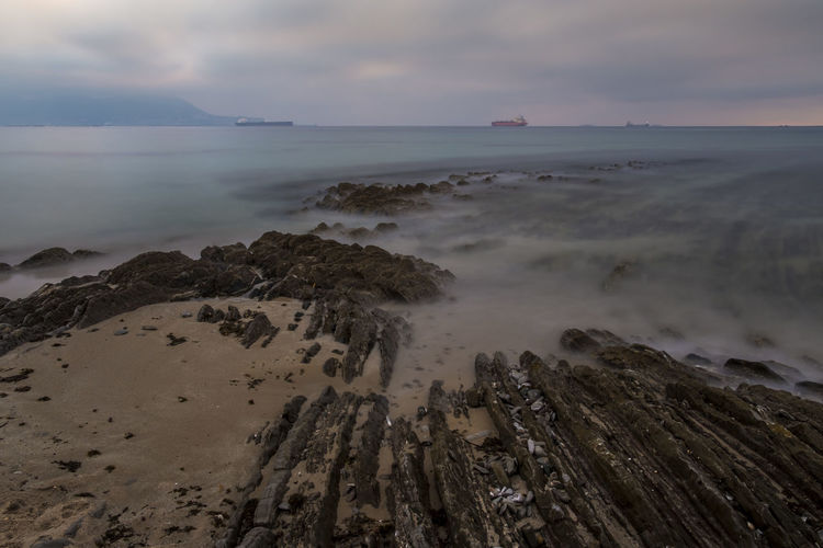Scenic view of sea against cloudy sky
