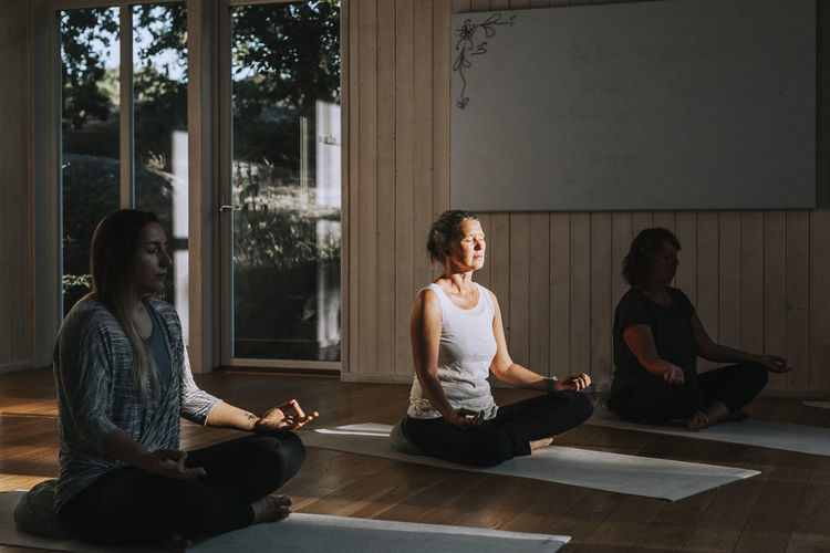 Women meditating in yoga studio