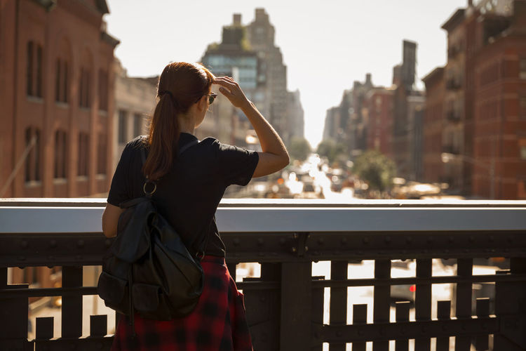 Rear view of woman looking at cityscape 
