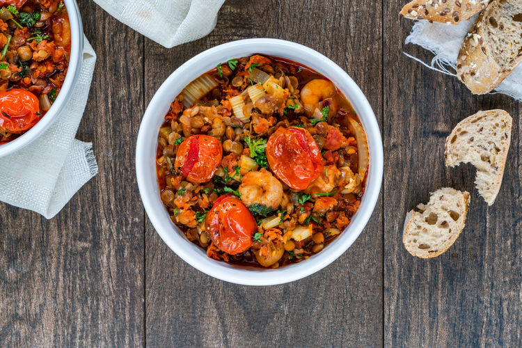 Chorizo, lentil and prawn stew with roasted tomatoes - overhead view