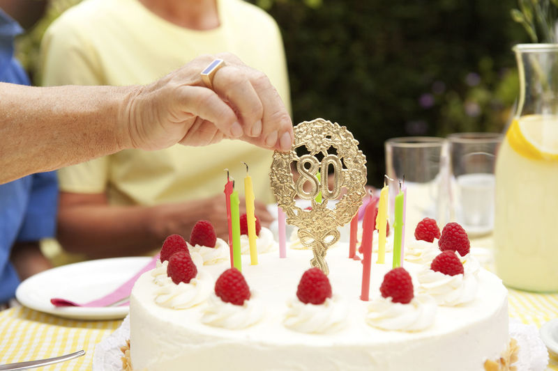 Midsection of woman holding cake