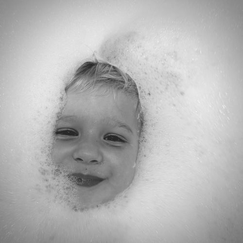 Close-up portrait of child in bathtub
