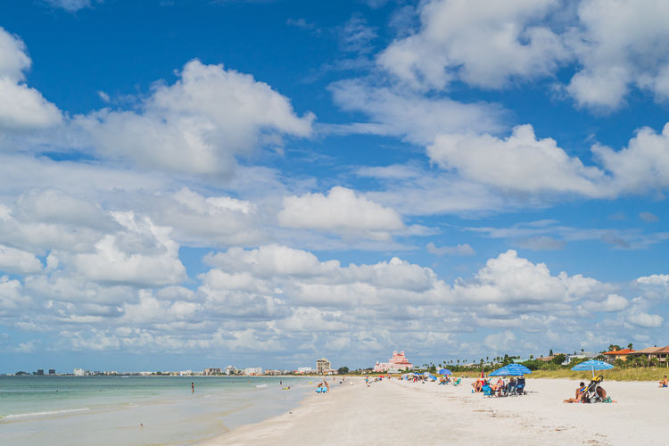 People on beach against sky