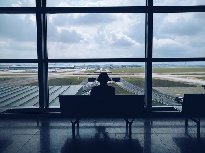 Rear view of person sitting at airport