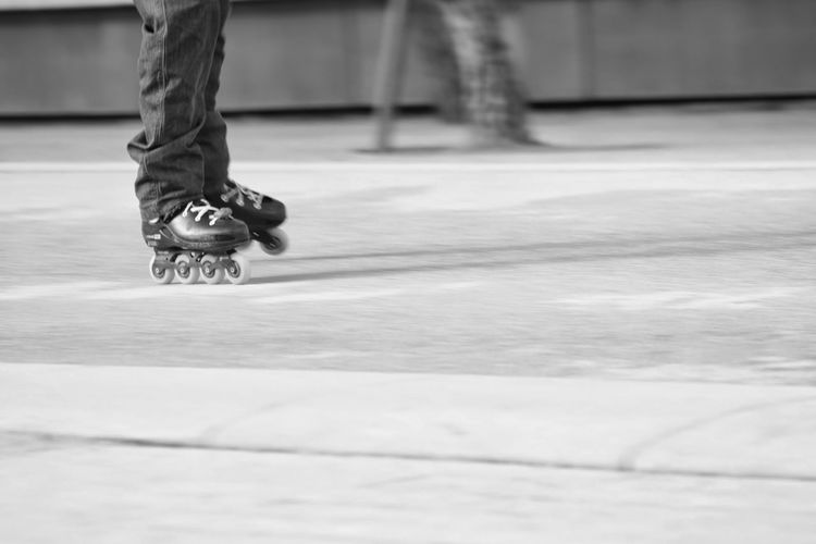 Low section of man skateboarding on floor