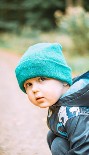 Close-up portrait of cute boy wearing hat