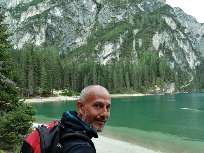 Portrait of man in lake against mountains