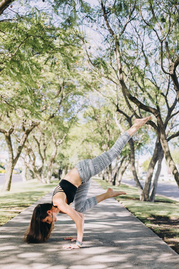 Woman of mexican ethnicity 35-39 years old doing a yoga pose of handstand with splits