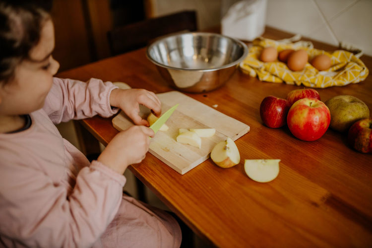 High angle view of boy preparing food on table