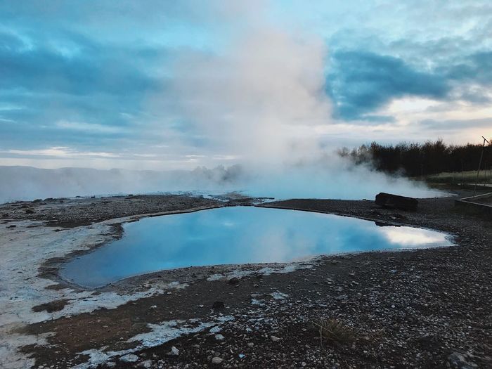 Scenic view of lake against cloudy sky