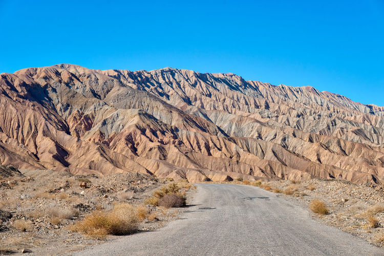 Scenic view of mountains against clear blue sky