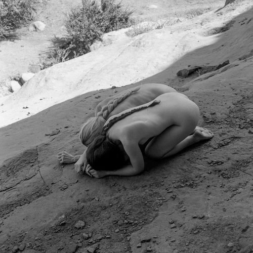 High angle view of woman lying on sand at beach