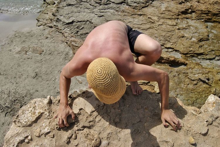 High angle view of man on rock at beach