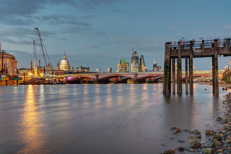 An old pier, the st pauls cathedral, blackfriars bridge and the city of london at dusk